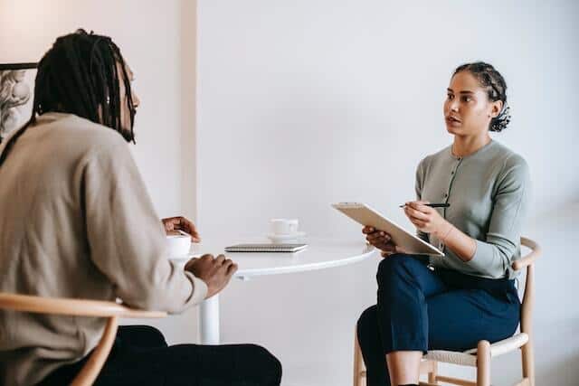 two-people-sitting-at-a-table-in-an-interview