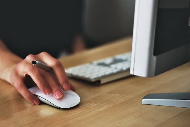 person-working-on-computer-holding-a-mouse