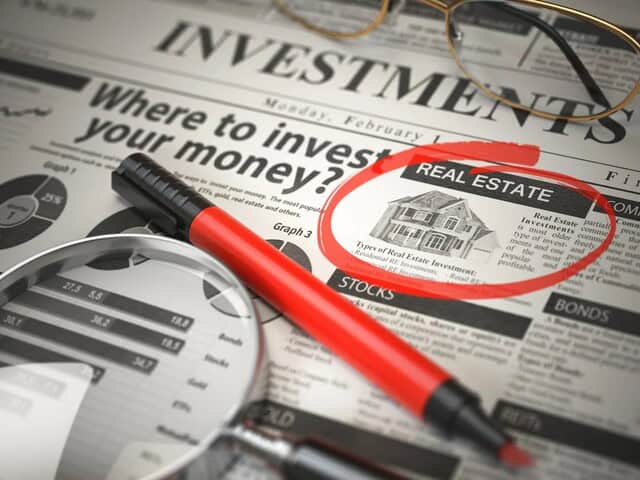 newspaper-with-the-question-where-to-onvest-your-money-with-the-word-real-estate-circled-with-a-red-marker-and a-magnifyine-glass