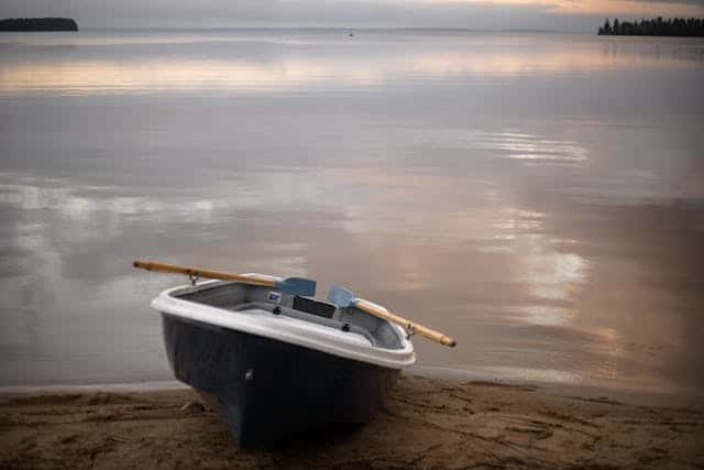 row-boat-resting-on-lakeshore