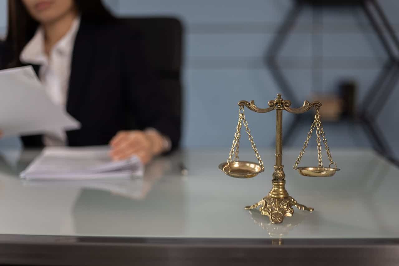 legal scales and person looking at papers